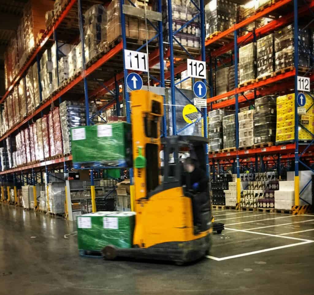 Forklift moving pallets through a warehouse