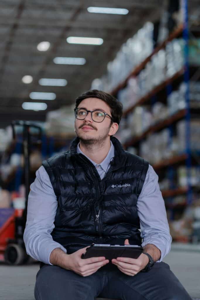 Warehouse manager checking inventory on a tablet